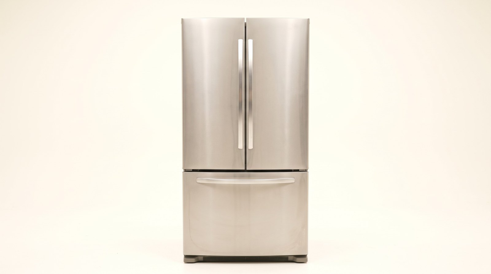 Refurbished stainless steel french door fridge on a plain background